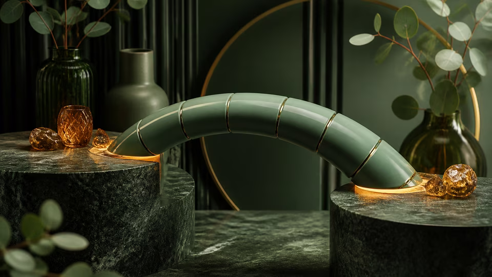 Green ceramic bridge joining two amber-lit stone platforms